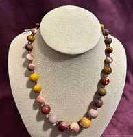 Full view of Mookaite jasper beaded necklace on display bust