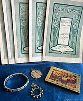 Group shot showing all six booklets, bracelet, medallion, rosary ring, icon plaque