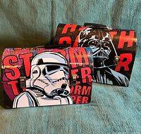 Both Star Wars laminated carry cases side by side showing graphics and general condition