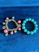 Both bracelets side by side on blue background