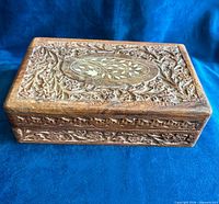 Closed box showing carved sides and lid inlay