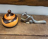 Wooden lidded bowl and squirrel nutcracker side by side