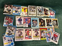 Overview of two sealed stacks and loose hockey cards spread out