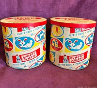 Front view of both matching tins showing graphics and lids