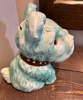 Right side profile of light teal ceramic Scottie dog coin bank showing collar and stopper area