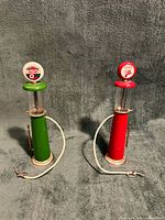 Front view of both green and red miniature gas pumps