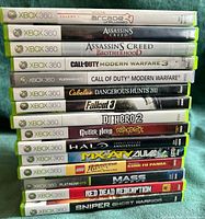 Spine view of all 15 Xbox 360 game cases stacked