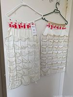 Front view of both hanging jewelry organizers showing pocket layout