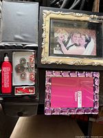 Group view showing both frames, clock parts tin, lubricant bottle and partially visible Jaguar pouch