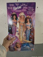 Back of Jewel Hair Mermaid Barbie box showing three dolls and branding