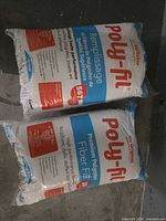 Two sealed Poly-fil bags on floor, full view