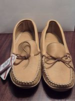 Top view of moccasins showing leather, stitching, laces