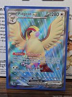 Front of sleeved Pidgeot ex secret rare card showing holographic foil and numbering 217/197
