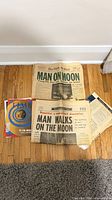 Lot overview showing two full newspapers, Time supplement, additional booklet and loose page