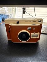 Front view of Lomo'Instant camera showing lens and body color