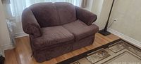 Front view of brown microfiber loveseat showing overall style