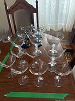 Assorted coupe glasses grouped on table showing size differences and total quantity