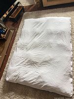 Top view of white featherbed mattress topper