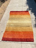 Full view of rug showing striped gradient pattern and overall dimensions