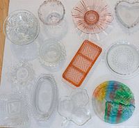 Overhead view of all twelve glass and crystal pieces arranged on white background