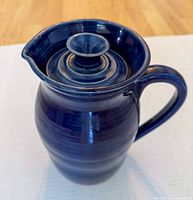 Front three-quarter view showing overall form, handle, spout and lid