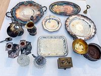 Overhead view of entire mixed lot including trays, dishes, glassware, key, and box