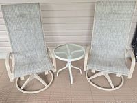 Front view of both swivel chairs and side table
