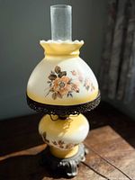 Full view of lamp showing floral opaline shade, metal filigree band, glass chimney and base