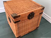 Full view of wicker trunk closed showing weave, hardware and corner protectors