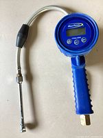 Full view of Blue-Point digital tire inflator with braided hose and chuck