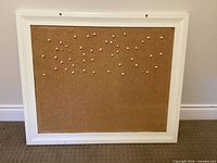 Front view of cork bulletin board with push pins
