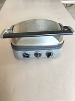 Front view of closed Cuisinart Griddler showing handle and control dials