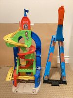 Overview of Fisher-Price playset showing main spiral tower and separate launch ramp