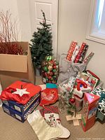 Group shot of entire lot including trees, ornaments, wrapping supplies, stands, candlesticks, stockings