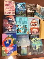 Front covers of ten books laid out on table