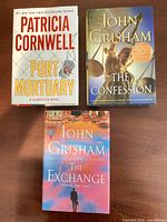 Cover fronts of three hardcover novels with dust jackets
