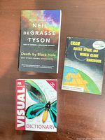 Front covers of three paperback books: Death by Black Hole; DK Ultimate Visual Dictionary; Cram Outer Space and World Globe Handbook