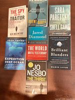 All seven books front covers visible