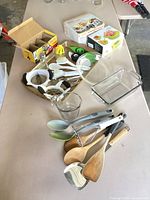 Overview of all utensils, glassware and boxed small tools spread on table