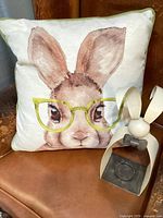 Front view of bunny pillow and metal candle holder