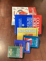 All six dictionaries and reference books laid out together