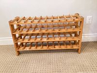 Full view of wooden wine rack showing four tiers and overall condition