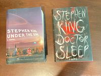 Both Stephen King hardcover novels side by side