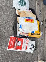Suitcase filled with stacks of assorted branded plastic bags