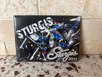 Front view of magnet showing motorcycle graphic and text