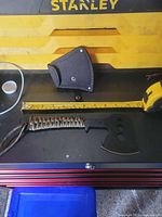 Hatchet, sheath, tape measure for scale