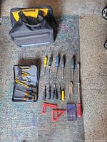 All items laid out with DeWalt bag, driver-bit kit, screwdrivers, pliers, squares, drill bits
