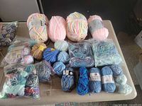 Assorted yarn skeins and balls in various colours and brands