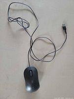 Top view of black Targus wired mouse with USB cable