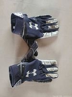 Gloves front and back view showing color, logos, overall condition